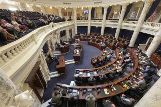 The Idaho House of Representatives meet for a special session at the Statehouse in Boise, Idaho, Thursday, Sept. 1, 2022. The session of the Legislature, called by Republican Gov. Brad Little, was convened to consider a massive income tax cut and education spending bill made possible by a $2 billion projected budget surplus. (AP Photo/Keith Ridler)