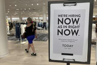 FILE - In this May 21, 2021 file photo, a customer walks behind a sign at a Nordstrom store seeking employees in Coral Gables, Fla. On Friday, Oct. 8, U.S. employers added just 194,000 jobs in September, a second straight tepid gain and evidence that the pandemic still has a grip on the economy with many companies struggling to fill millions of open jobs. (AP Photo/Marta Lavandier, File)