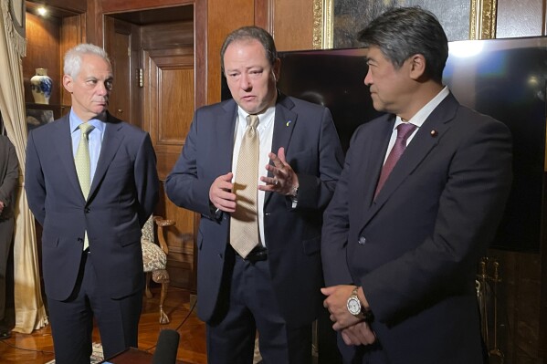 U.S. Ambassador to Japan Rahm Emanuel, left, Ukraine Ambassador to Japan Sergey Korsunsky, center, and acting secretary general of the governing Liberal Democratic Party Seiji Kihara speak to the media in Tokyo, Japan, Thursday Dec. 7, 2023. (AP Photo/Mari Yamaguchi)