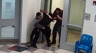 This still image from a security camera provided by Sedgwick County shows Cedric "CJ" Lofton struggling with staff on Sept. 24, 2021 at the Sedgwick County Juvenile Intake and Assessment Center in Wichita, Kan.  Sedgwick County released 18 video clips late Friday, Jan. 21, 2022, of what happened before Lofton was rushed to a hospital on Sept. 24. He died two days later.  (Sedgwick County via AP)