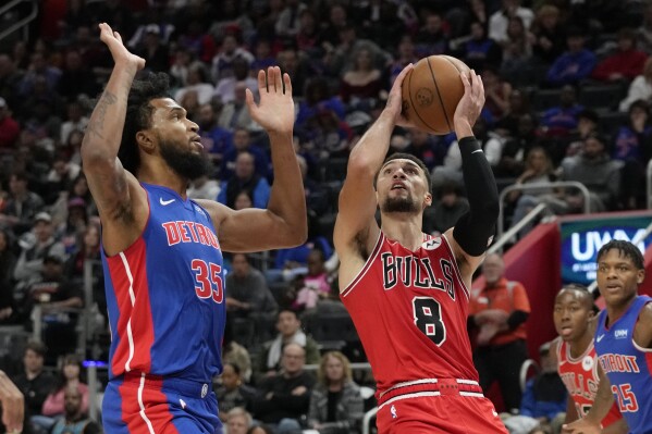 Chicago Bulls guard Zach LaVine (8) attempts a layup as Detroit Pistons forward Marvin Bagley III (35) defends during the second half of an NBA basketball game, Saturday, Oct. 28, 2023, in Detroit. (AP Photo/Carlos Osorio)