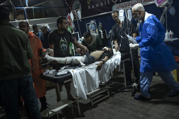 A Palestinian wounded in the Israeli bombardment of the Gaza Strip arrives at a hospital in Rafah on Wednesday, Dec.13, 2023. (AP Photo/Fatima Shbair)