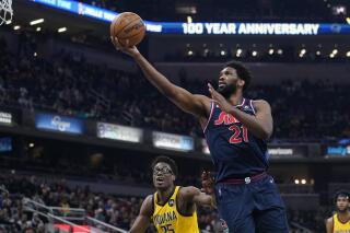 Philadelphia 76ers' Joel Embiid shoots against Indiana Pacers' Jalen Smith during the first half of an NBA basketball game Tuesday, April 5, 2022, in Indianapolis. (AP Photo/Darron Cummings)