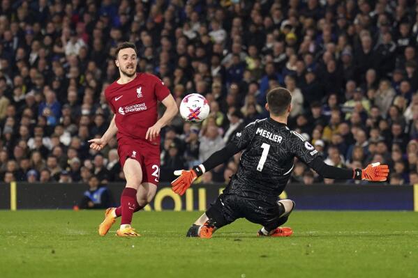 Liverpool's Diogo Jota, left, scores during the Premier League match between Leeds United and Liverpool FC at Elland Road, Leeds, England, Monday April 17, 2023. (Tim Goode/PA via AP)