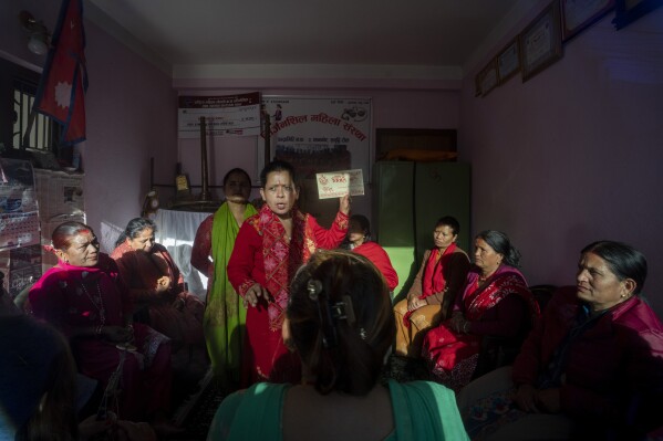 Bal Kumari Bhusal, the leader of Shrijanshil Mahila Sanstha, or the Self-Reliant Women’s Group, briefs her band members about their upcoming wedding performance in Kathmandu, Nepal, Tuesday, March 5, 2024. (AP Photo/Niranjan Shrestha)