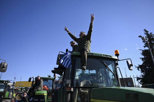 Protesting farmers with their tractors take part in a rally outside the annual Agrotica trade fair in the port city of Thessaloniki, northern Greece, Saturday, Feb. 3, 2024. Greek farmers – hit by rising costs and crop damage caused by recent floods and wildfires – gathered around the conference center hosting the event in the northern city of Thessaloniki to underline their determination to escalate protests over rising production costs by blocking highways. (AP Photo/Giannis Papanikos)