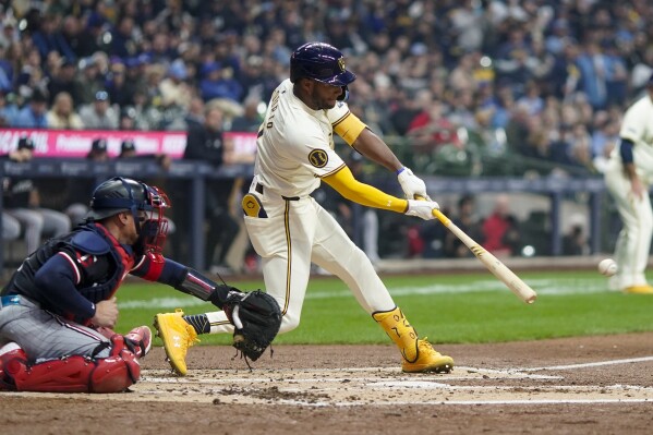 Milwaukee Brewers' Jackson Chourio hits an RBI single during the second inning of a baseball game against the Minnesota Twins Tuesday, April 2, 2024, in Milwaukee. (AP Photo/Morry Gash)