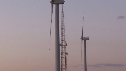 The sun sets behind land-based wind turbines in Atlantic City N.J. on Feb. 10, 2022. The U.S. Government Accountability Office on Thursday, June 15, 2023, agreed to look into the potential impacts of offshore wind energy development on the U.S. East Coast, fulfilling a long time demand from opponents of such projects. (AP Photo/Wayne Parry)