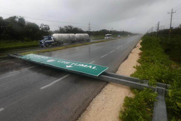 A road sign brought down by the winds of Hurricane Grace straddles one lane of a highway in Tulum, Quintana Roo state, Mexico, Thursday, Aug. 19, 2021. The Category 1 storm made landfall at 4:45 a.m., just south of the ancient Mayan temples of Tulum, pelting the Caribbean coast with heavy rain and pushing a dangerous storm surge. (AP Photo/Marco Ugarte)