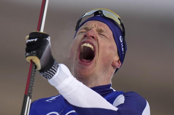 Iivo Niskanen, of Finland, celebrates after finishing the men's 15km classic cross-country skiing competition at the 2022 Winter Olympics, Friday, Feb. 11, 2022, in Zhangjiakou, China. (AP Photo/Alessandra Tarantino)