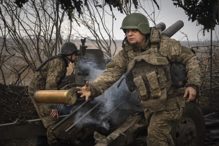 FILE - Ukrainian soldiers with the 71st Jaeger Brigade fire a M101 howitzer at Russian positions on the front line, near the city of Avdiivka in Ukraine’s Donetsk region, on March 22, 2024. (AP Photo/Efrem Lukatsky, File)
