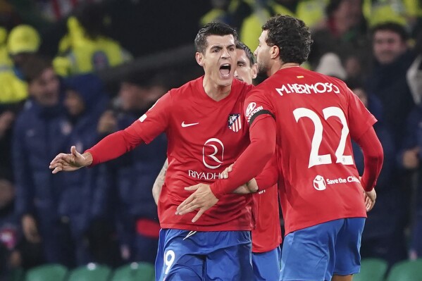 Atletico Madrid's Alvaro Morata, left, celebrates scoring his side's second goal of the game with teammates, during the Champions League Group E match between Celtic Glasgow and Atletico Madrid, at Celtic Park, in Glasgow, Scotland, Wednesday, Oct. 25, 2023. (Andrew Milligan/PA via AP)