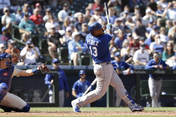 Kansas City Royals' Salvador Perez (13) hits a home run as Seattle Mariners catcher Cal Raleigh, left, looks on during the sixth inning of a baseball game Sunday, Aug. 29, 2021, in Seattle. (AP Photo/Jason Redmond)