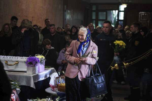 A woman cries during a funeral ceremony for Tamara Martyniuk, 8, Stanislav Martyniuk, 12, and Roman Martyniuk, 17, killed in a Russian strike on Sunday, in Korostyshiv, Zhytomyr region, Ukraine, Wednesday, May 28, 2025. (AP Photo/Evgeniy Maloletka)