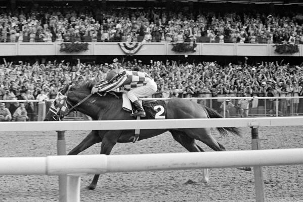 FILE - Ron Turcotte hangs on as Secretariat romps along the final stretch just before the finish line and a victory in the 105th running of the Belmont Stakes at Belmont Park in Elmont, N.Y., June 9, 1973. (AP Photo/File)