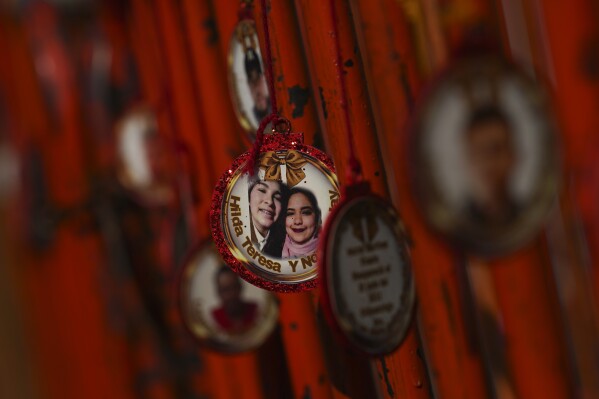 Ornaments hang from a crowd control barrier during a 