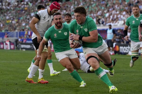 Ireland's Joe McCarthy runs in to score a try during the Rugby World Cup Pool B match between Ireland and Romania at the Stade de Bordeaux in Bordeaux, France, Saturday, Sept. 9, 2023. (AP Photo/Themba Hadebe)