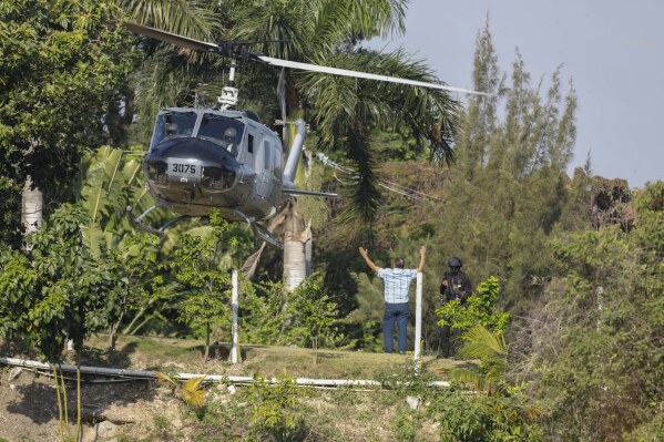 A helicopter lands to evacuate personnel at the Dominican embassy in Port-au-Prince, Haiti, Thursday, March 21, 2024. (AP Photo/Odelyn Joseph)