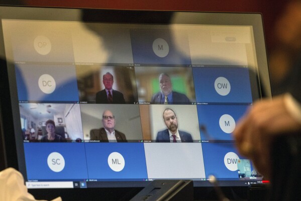 A screen for a teleconference is shown in court in Las Vegas, on Monday, Dec. 18, 2023, where six Republicans pleaded not guilty to two felony charges each, stemming from their roles as fake electors in 2020 where they signed certificates falsely claiming former President Donald Trump won Nevada over Joe Biden. (AP Photo/Ty O'Neil)