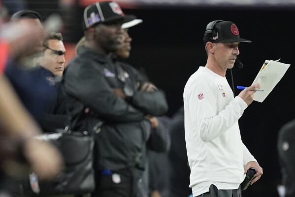 San Francisco 49ers head coach Kyle Shanahan looks at notes during the second half of the NFL Super Bowl 58 football game against the Kansas City Chiefs Sunday, Feb. 11, 2024, in Las Vegas. (AP Photo/George Walker IV)