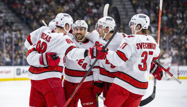 Carolina Hurricanes celebrate a goal against the Golden Knights during the first period of an NHL hockey game Tuesday, Nov. 16, 2021, in Las Vegas. (AP Photo/L.E. Baskow)