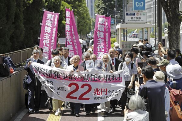 Plaintiffs march into the Tokyo High Court for a ruling on former executives of the Tokyo Electric Power Company Holdings' accountabilities for the 2011 meltdown crisis, at the Tokyo court Friday, June 6, 2025. (Masanori Kumagai/Kyodo News via AP)