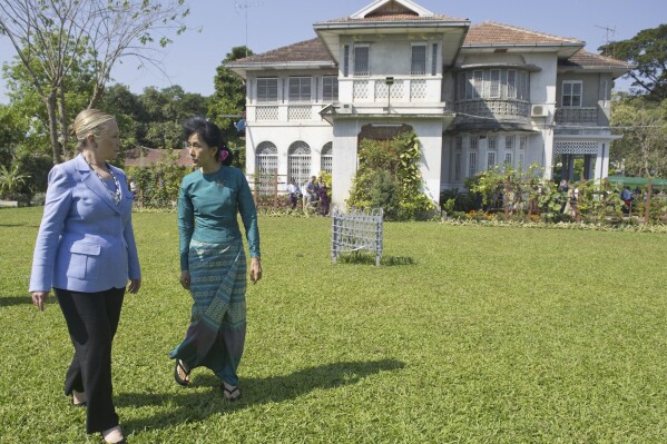 FILE - Myanmar's pro-democracy opposition leader Aung San Suu Kyi, right, and U.S. Secretary of State Hillary Rodham Clinton walk through the garden after meetings at Suu Kyi's residence in Yangon, Myanmar on Dec. 2, 2011. No bidders appeared at a court-ordered auction Wednesday, March 20, 2024 of the family home of Myanmar's imprisoned former leader, Aung San Suu Kyi, where she had been held under house arrest for nearly 15 years, legal officials said. (Saul Loeb/Pool Photo via AP, File)