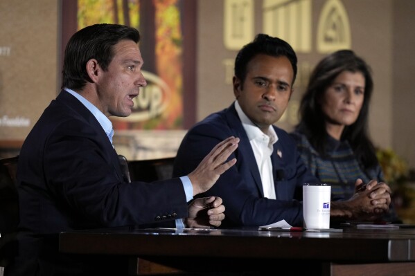 Republican presidential candidate Florida Gov. Ron DeSantis speaks during the Family Leader's Thanksgiving Family Forum as Republican presidential candidate businessman Vivek Ramaswamy, center, and Republican presidential candidate former U.N. Ambassador Nikki Haley, right, watch, Friday, Nov. 17, 2023, in Des Moines, Iowa. (AP Photo/Charlie Neibergall)