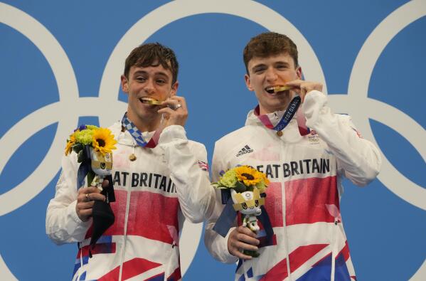 Thomas Daley and Matty Lee of Britain pose for a photo after winning gold medals during the men's synchronized 10m platform diving final at the Tokyo Aquatics Centre at the 2020 Summer Olympics, Monday, July 26, 2021, in Tokyo, Japan. (AP Photo/Dmitri Lovetsky)