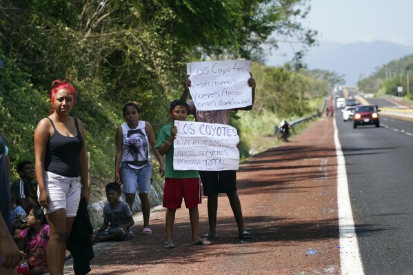 Residents hold help signs that read in Spanish "We need food. Support. We are homeless" two days after the passage of Hurricane Otis as a Category 5 storm in Los Coyotes near Acapulco, Mexico Friday, Oct. 27, 2023. (AP Photo/Marco Ugarte)