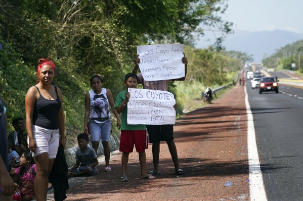 Residents hold help signs that read in Spanish 