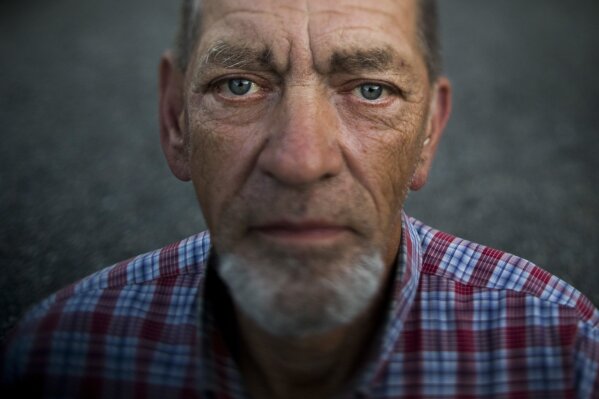 
              Robert Irwin, 72, poses for a photo at Camp Second Chance, a city-sanctioned homeless encampment, Tuesday, Sept. 26, 2017, in Seattle. Irwin said he is planning a trip to Michigan to see his older sister. "I have my own SUV, Chevy Trailblazer. I want to go in March. It will be my last trip." (AP Photo/Jae C. Hong)
            