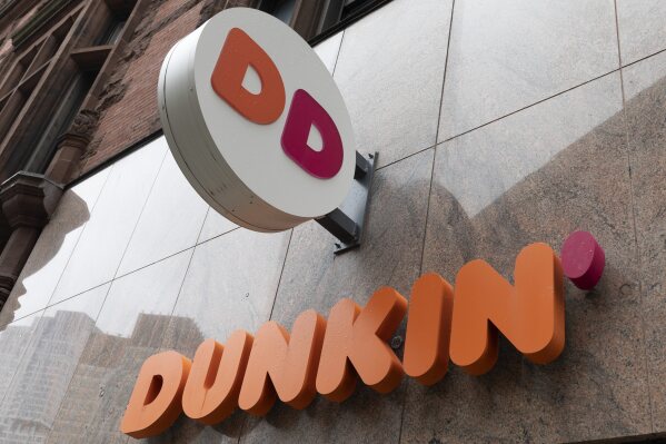 File - The Dunkin' logo is seen on a storefront, Friday, Oct. 14, 2022, in Boston. Reward programs have long been a way for brands to build loyalty and incentivize spending. But now some companies are becoming a bit more stingy, and customers are taking notice. Last fall, for example, many balked at Dunkin's decision to stop offering a free drink on their birthday and instead give them triple loyalty points on their purchase. (APPhoto/Michael Dwyer, File)