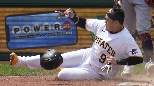 Pittsburgh Pirates' Ji Man Choi scores the second of two runs on a single by Jared Triolo off Cleveland Guardians relief pitcher Enyel De Los Santos during the seventh inning of a baseball game in Pittsburgh, Wednesday, July 19, 2023. The Pirates won 7-5. (AP Photo/Gene J. Puskar)