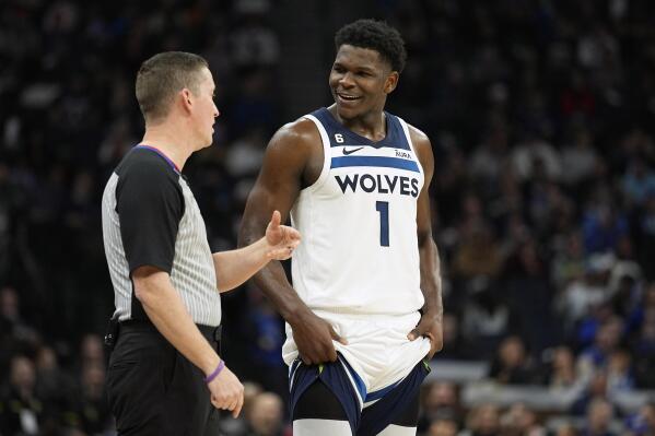 Minnesota Timberwolves guard Anthony Edwards (1) talks with referee Nick Buchert, left, during the second half of an NBA basketball game against the Dallas Mavericks, Monday, Dec. 19, 2022, in Minneapolis. (AP Photo/Abbie Parr)