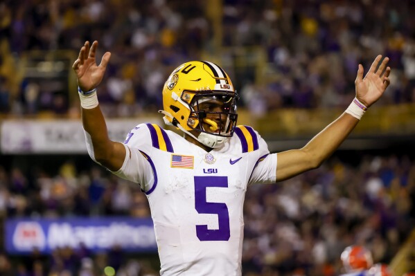 LSU quarterback Jayden Daniels (5) celebrates after a touchdown against Florida during the second half of an NCAA college football game in Baton Rouge, La., Saturday, Nov. 11, 2023. (AP Photo/Derick Hingle)