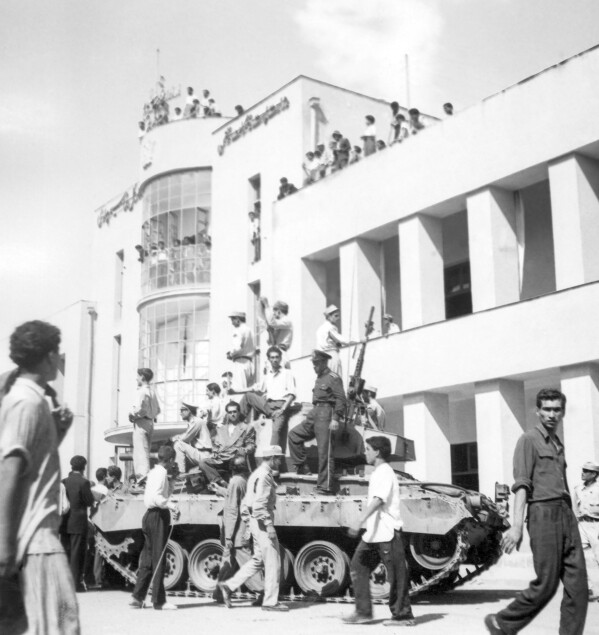 FILE - A royalist tank moves into the courtyard of Tehran Radio a few minutes after pro-shah troops occupied the area during the coup which ousted Mohammad Mossadegh and his government on Aug. 19, 1953. While revealing new details about one of the most famed CIA operations of all times, the spiriting out of six American diplomats who escaped the 1979 U.S. Embassy seizure in Iran, the intelligence agency for the first time has acknowledged something else as well. The CIA now officially describes the 1953 coup it backed in Iran that overthrew its prime minister and cemented the rule of Shah Mohammad Reza Pahlavi as undemocratic. (AP Photo, File)