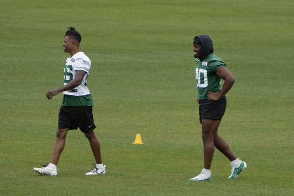 New York Jets' Brandin Echols, left, and Breece Hall work on the side during a practice at the NFL football team's training facility in Florham Park, N.J., Tuesday, June 11, 2024. (AP Photo/Seth Wenig)