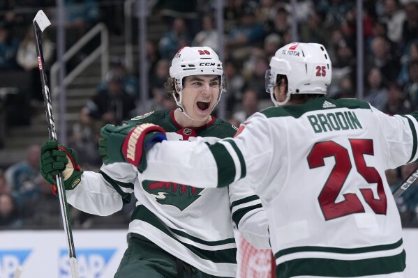 Minnesota Wild left wing Liam Ohgren celebrates with Jonas Brodin (25) after scoring a goal against the San Jose Sharks during the second period of an NHL hockey game in San Jose, Calif., Saturday, April 13, 2024. (AP Photo/Tony Avelar)
