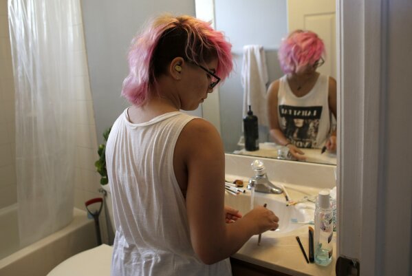 
              In this Thursday, June 22, 2017 photo, Theo Ramos, 15, cleans makeup brushes at home in Homestead, Fla. Ramos is embracing his gender fluidity, meaning that whether he identifies as male or female can change, depending on day or mood. (AP Photo/Lynne Sladky)
            