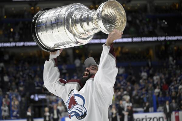 FILE - Colorado Avalanche center Nazem Kadri (91) lifts the Stanley Cup after the team defeated the Tampa Bay Lightning in Game 6 of the NHL hockey Stanley Cup Finals on June 26, 2022, in Tampa, Fla. Kadri has signed a seven-year, $49 million contract with the Flames, the team announced Thursday, Aug. 18, 2022. (AP Photo/Phelan M. Ebenhack, File)