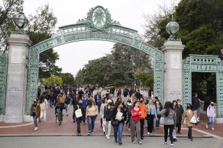 File - Students make their way through the Sather Gate near Sproul Plaza on the University of California, Berkeley, campus March 29, 2022, in Berkeley, Calif. The Free Application for Federal Student Aid is available for the 2024-2025 school year, three months later than usual. (AP Photo/Eric Risberg, File)