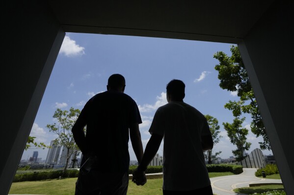 A gay Chinese couple looks at a facility during a condominium tour in Bangkok, Thailand, Friday, Aug. 18, 2023. LGBTQ+ people from China who are frequently scorned and ostracized at home are coming to Thailand in droves. They're drawn by the freedom to be themselves. Bangkok is only a 5-hour flight from Beijing, and Thailand's tourism authorities actively promote its status as among the most open to LGBTQ+ people in the region.(AP Photo/Sakchai Lalit)