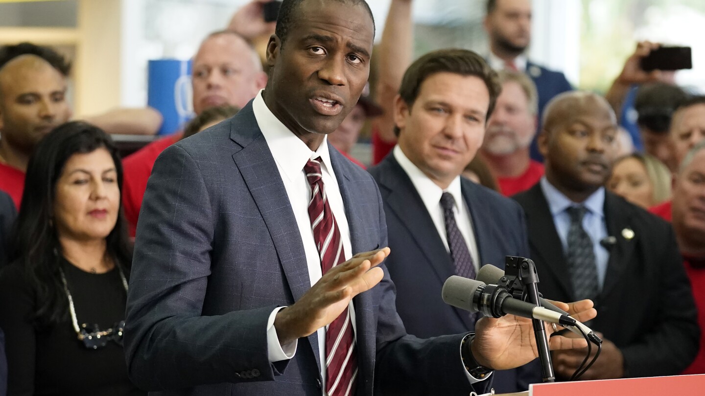 FILE - Florida Surgeon General Dr. Joseph Ladapo gestures as speaks to supporters and members of the media before a bill signing by Gov. Ron DeSantis 