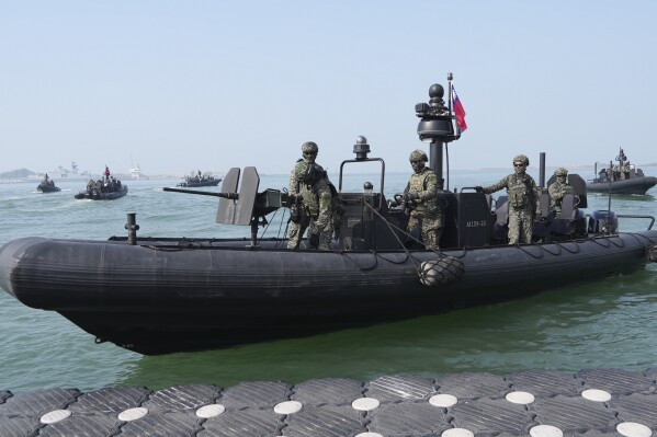 Members of the Taiwanese Marines stand guard on the assault craft at Zouying Navy Base in Kaohsiung, Southern Taiwan on Wednesday, Jan. 31, 2024. Taiwan is holding spring military drills following its recent presidential election and amid threats from China, which claims the island as its own territory that it is determined to annex, possibly by force. (AP Photo/Christopher Bodeen)