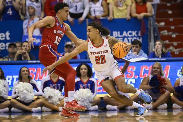 Texas Tech guard Jaylon Tyson (20) drives around Kansas guard Kevin McCullar Jr. (15) during the first half of an NCAA college basketball game in Lawrence, Kan., Tuesday, Feb. 28, 2023. (AP Photo/Reed Hoffmann)