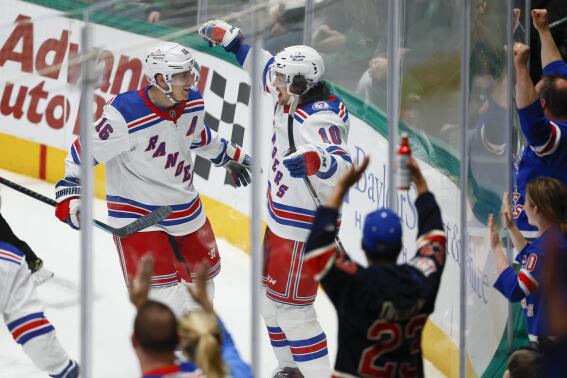 New York Rangers forward Artemi Panarin (10) is congratulated by forward Ryan Strome (16) after scoring against the Dallas Stars during the first period of an NHL hockey game Saturday, March 12, 2022, in Dallas. (AP Photo/Brandon Wade)