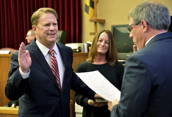 Washington County Circuit Court Clerk Kevin Tucker, right, swears in Andrew F. Wilkinson as a circuit court judge on Jan. 10, 2020, as Wilkinson's wife, Stephanie, watches. Wilkinson was found with apparent gunshot wounds around 8 p.m. Thursday, Oct. 19, 2023, the Washington County Sheriff’s Office said in a statement. Wilkinson was taken from his home in Hagerstown to Meritus Medical Center, where he died of his injuries, the sheriff's office said. ( Julie E. Greene/The Herald-Mail via AP)
