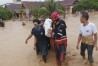 In this Friday, May 3, 2024, photo released by the Wajo Regional Disaster Management Agency (BPBD Wajo), rescuers carry a victim of a flood in Wajo, South Sulawesi, Indonesia. A flood and a landslide hit Indonesia's Sulawesi island, killing a number of people, officials said Saturday. (BPBD Wajo via Ǻ)