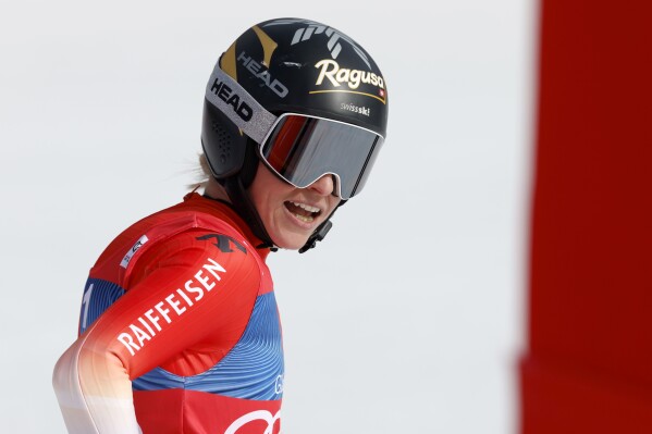 Switzerland's Lara Gut Behrami checks her time at the finish area of an alpine ski, women's World Cup super-G race, in Saalbach, Austria, Friday, March 22, 2024. (AP Photo/Alessandro Trovati)